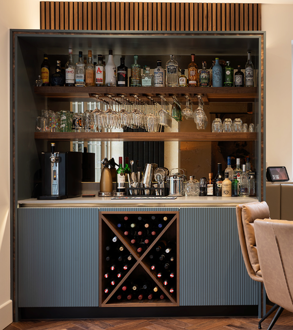 triple tier frame on bespoke kitchen bar unit with shelves for glass, bottles, cruciform wine rack and ribbed doors