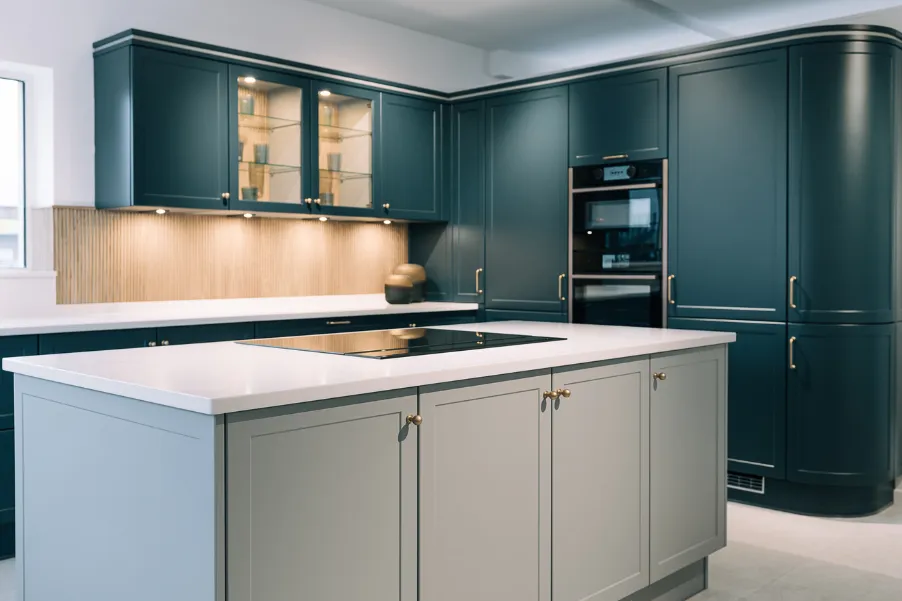 Stoneham kitchen displays including an island and curved tall cabinets in kitchen showroom in Chichester