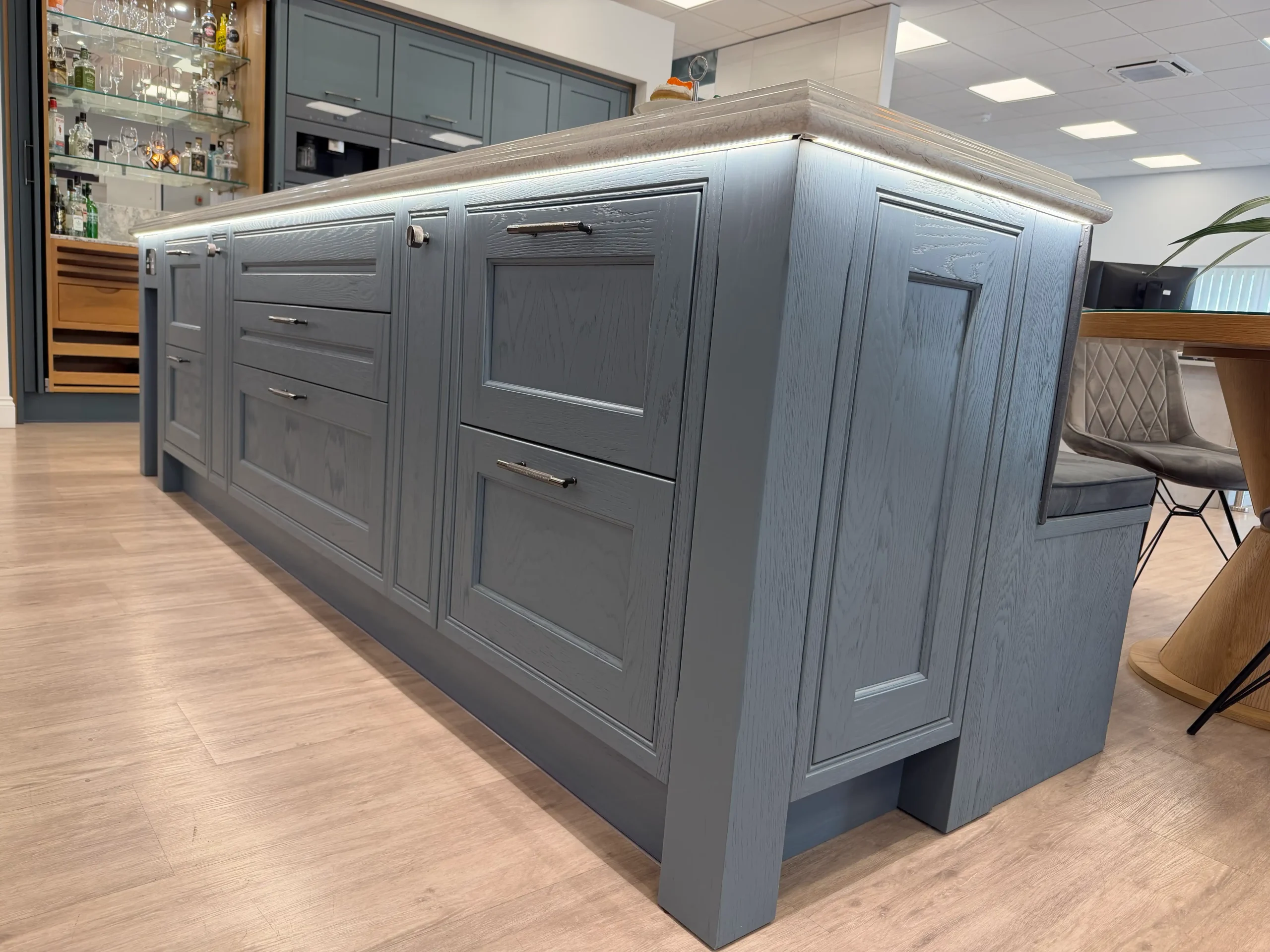 Close up of a kitchen island with lighting and worktop