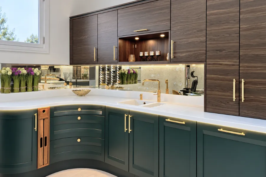 Curved kitchen units in dark blue with wooden top cabinets