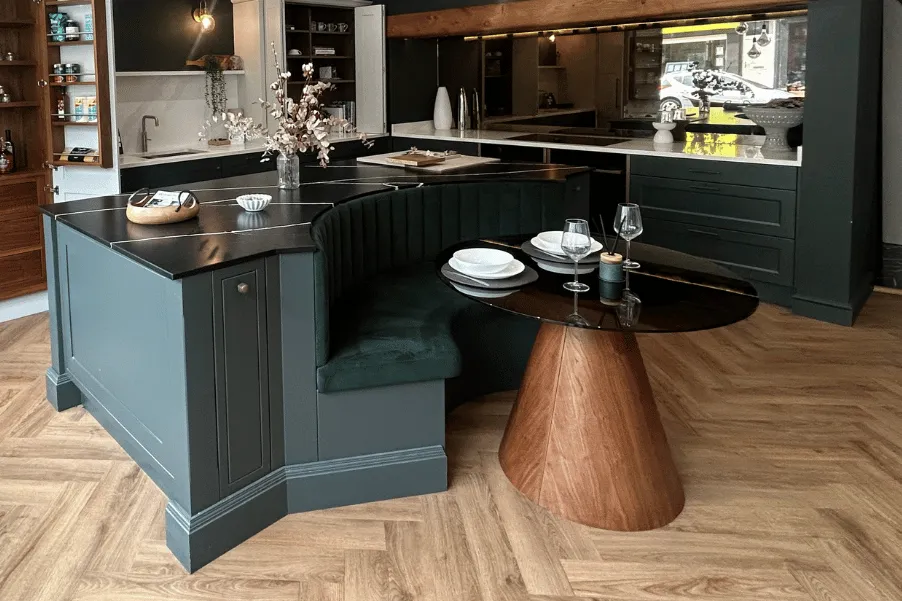 Cosy booth with cylinder wooden table integrated onto kitchen island