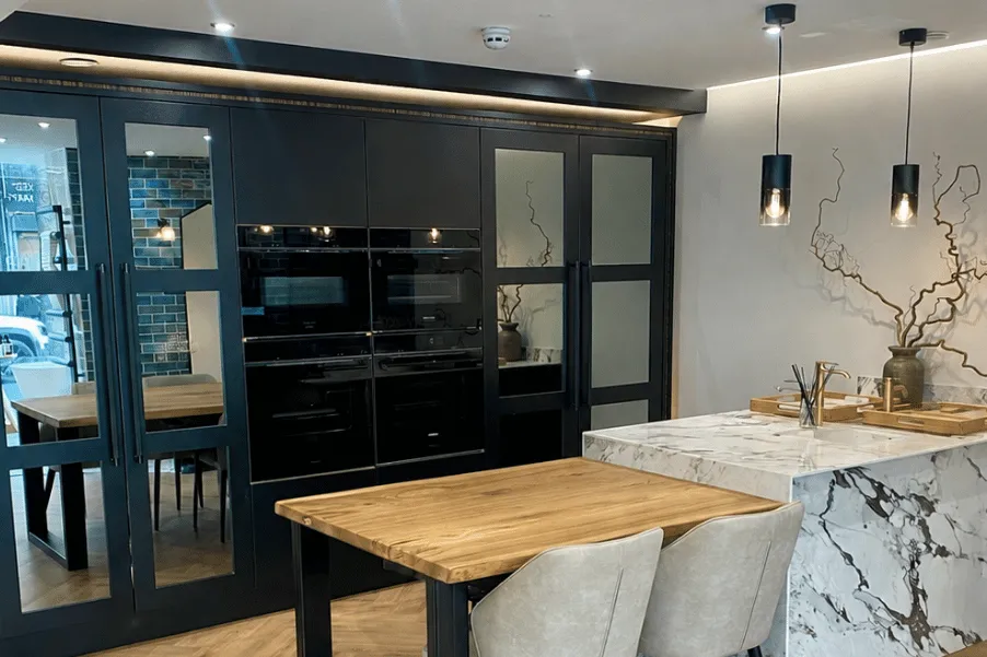 Dark tall mirrored cabinets with trim detail and lighting