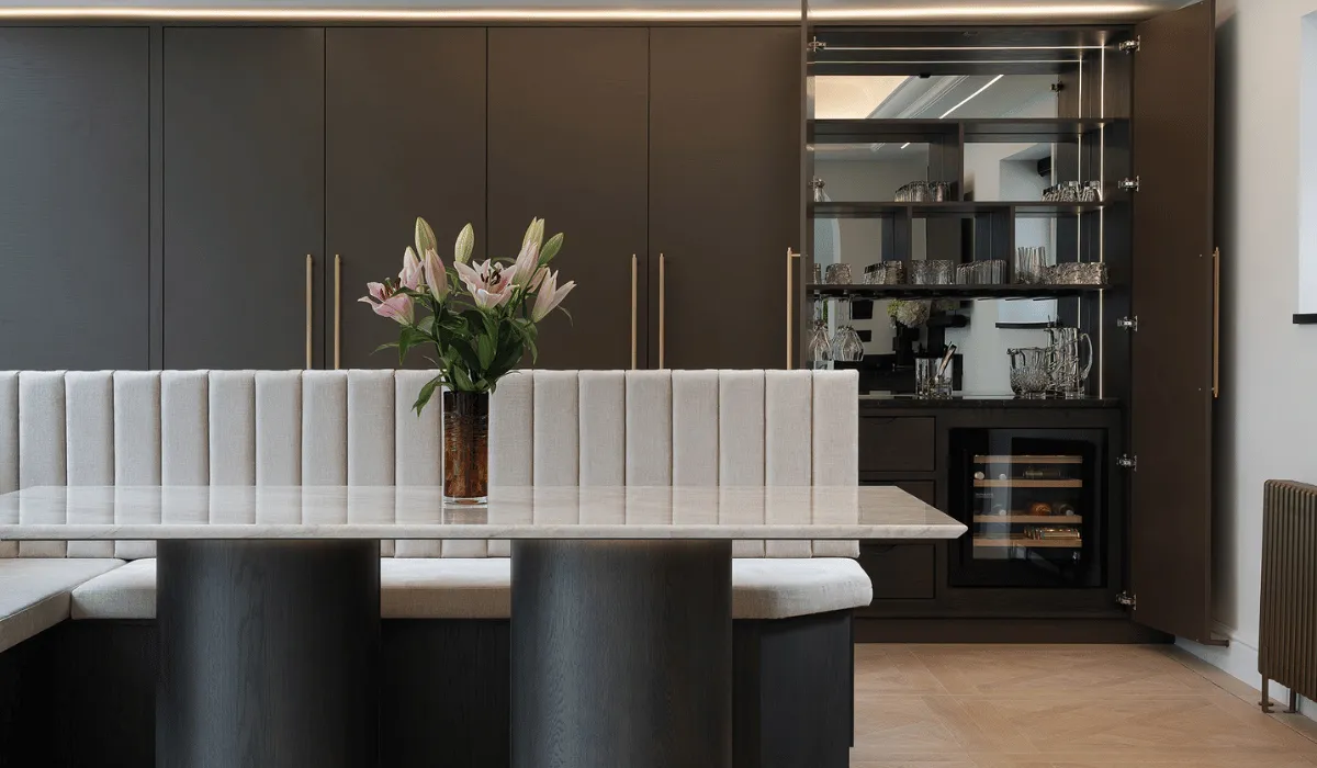 contemporary brown kitchen with booth seating and pantry bar cupboard with wine cooler