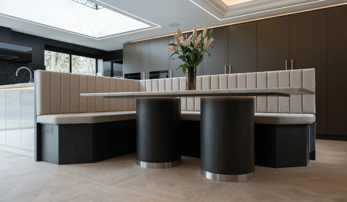 Large kitchen booth with wooden cylinder leg supports and cushioned l-shaped bench