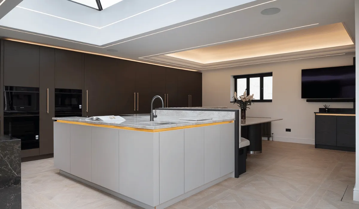 large kitchen island with cashmere high gloss cabinets and tall dark oak kitchen units behind