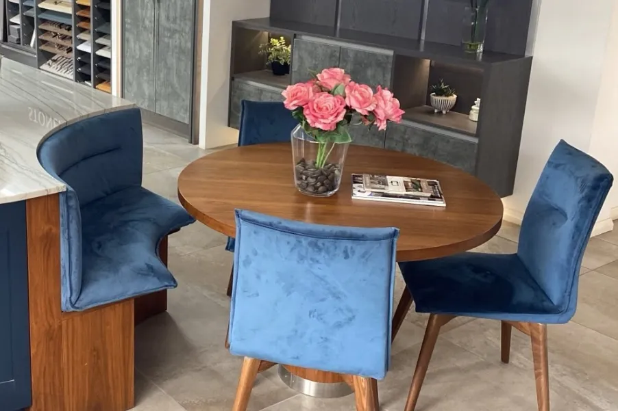 Curved kitchen booth with table and blue velvet chairs