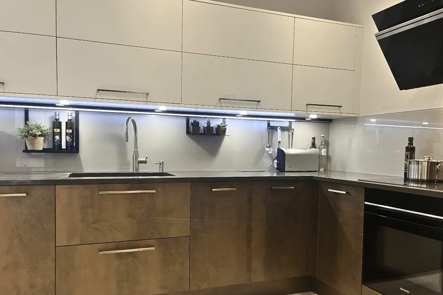 Contemporary kitchen with lower metallic effect kitchen doors and cream high cabinets