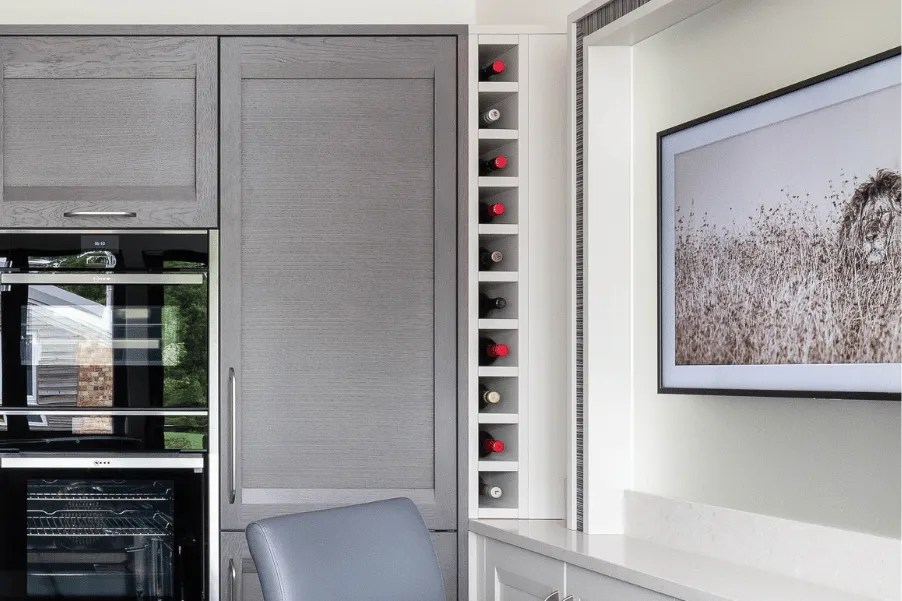 vertical wine storage integrated into tall cabinetry run