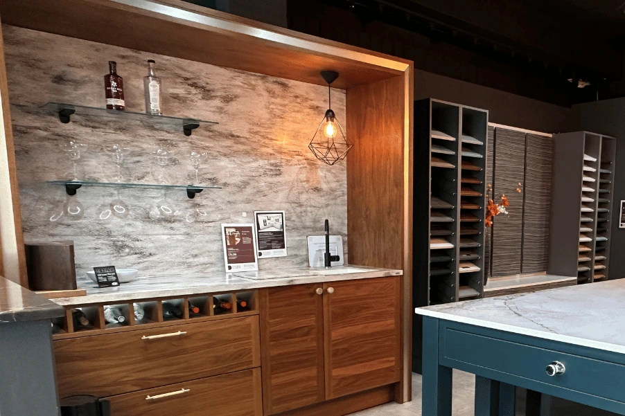 Large bespoke wooden bar with veined worktop and splashback and wine storage