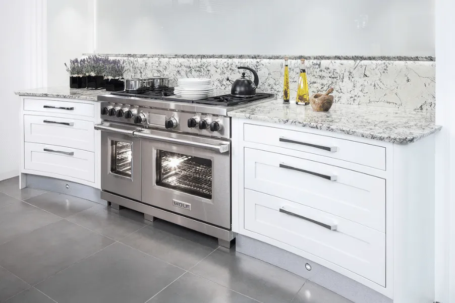 Curved Stoneham kitchen cabinetry with stainless steel range cooker