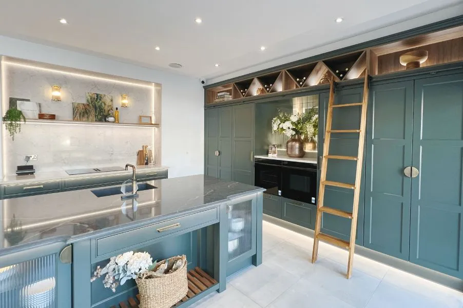 green stoneham kitchen with island and tall cabinetry with ladder rail system