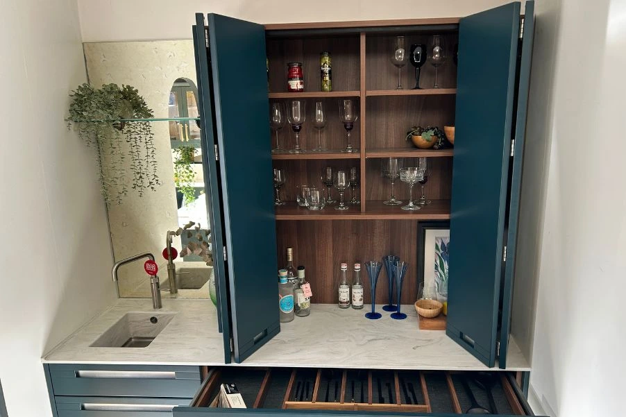 bespoke blue drinks station with bi-fold doors and wooden interior