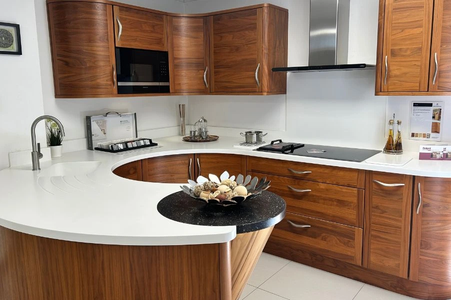 Curved wooden kitchen with white worktops